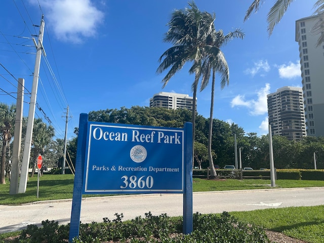 community sign featuring a lawn