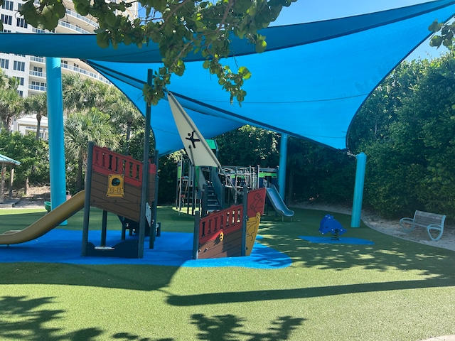 view of jungle gym featuring a lawn