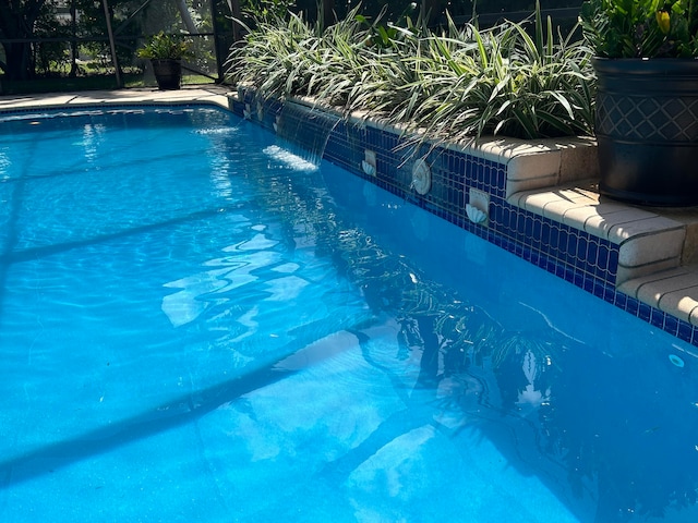 view of pool with pool water feature