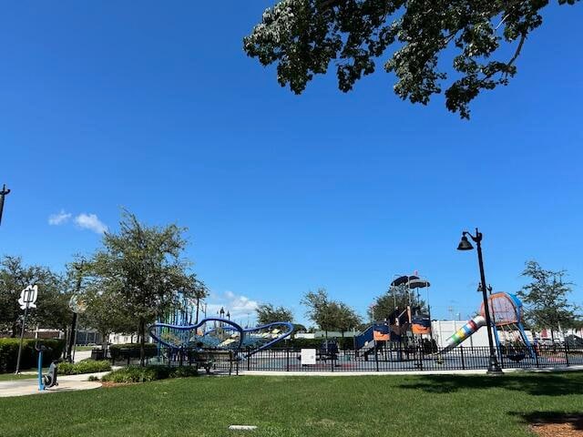 view of property's community featuring a playground and a yard