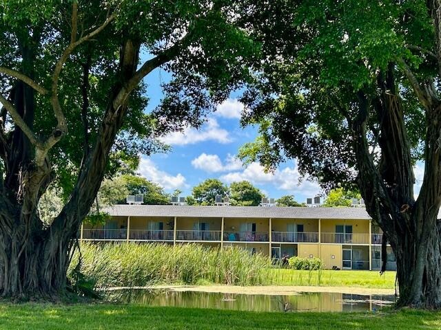 ranch-style home with a water view and a balcony