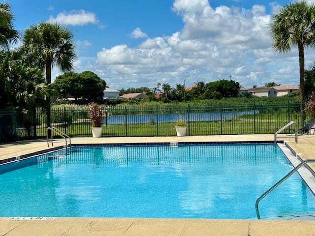 view of pool featuring a water view