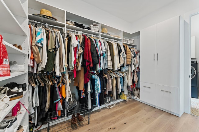 walk in closet featuring washer / clothes dryer and wood finished floors