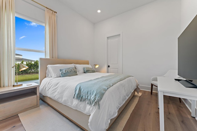 bedroom with recessed lighting, baseboards, and wood finished floors