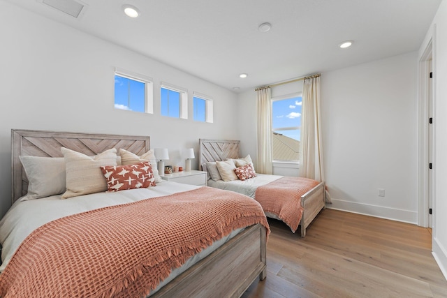 bedroom with visible vents, recessed lighting, light wood-style floors, and baseboards