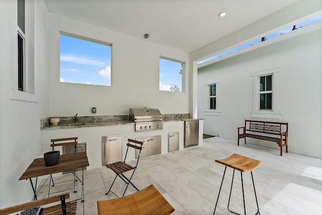 interior space with area for grilling, an outdoor kitchen, and sink