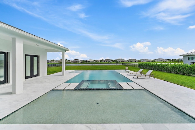 view of pool featuring a patio area, a yard, and an in ground hot tub