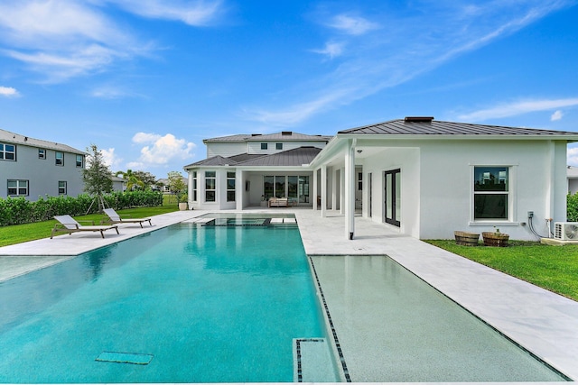 pool featuring a lawn and a patio area