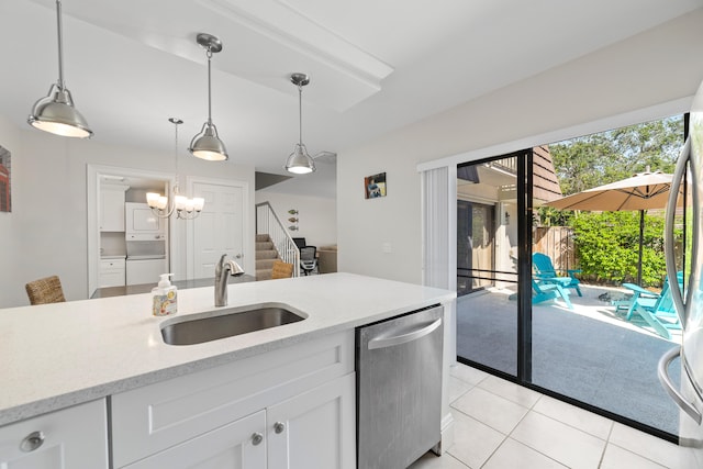 kitchen with stainless steel dishwasher, sink, washing machine and clothes dryer, and white cabinetry