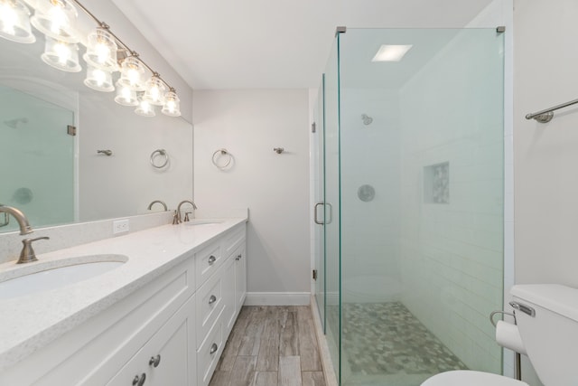 bathroom with an enclosed shower, wood-type flooring, vanity, and toilet