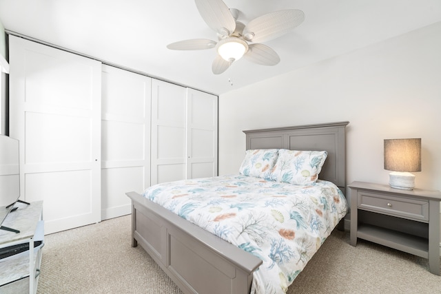 carpeted bedroom featuring ceiling fan and a closet