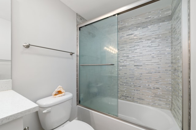 bathroom with bath / shower combo with glass door and toilet