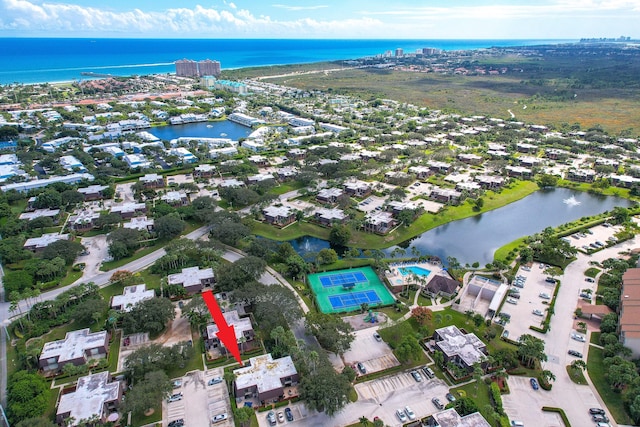 birds eye view of property with a water view