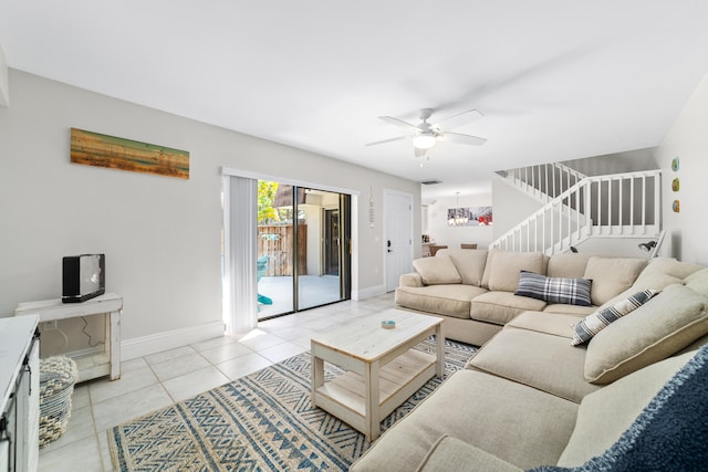 living room featuring ceiling fan with notable chandelier and light tile patterned floors