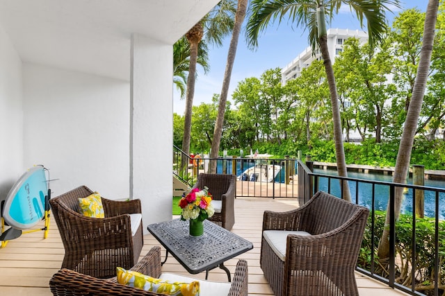 wooden balcony with an outdoor living space and a wooden deck