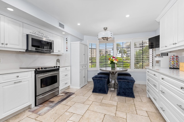 kitchen featuring appliances with stainless steel finishes and white cabinetry