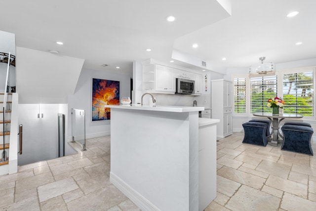 kitchen with white cabinets and kitchen peninsula