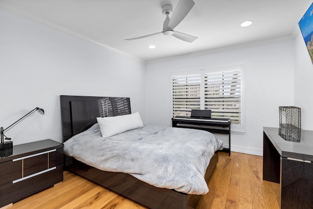 bedroom featuring ceiling fan, light hardwood / wood-style flooring, and ornamental molding