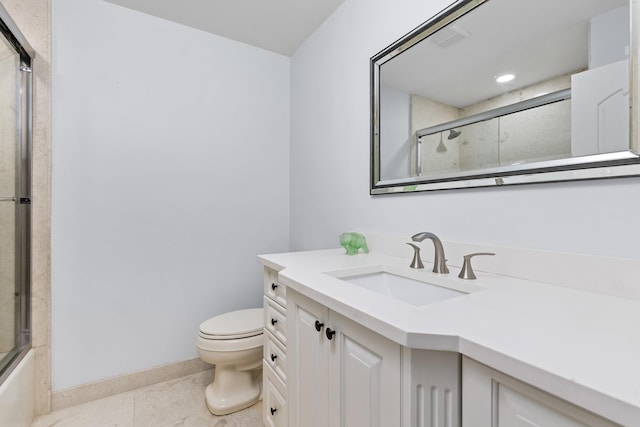 full bathroom featuring bath / shower combo with glass door, vanity, toilet, and tile patterned floors