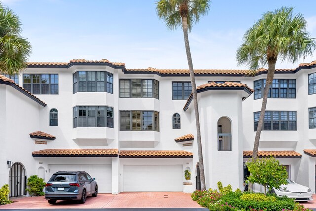 mediterranean / spanish-style house with a garage