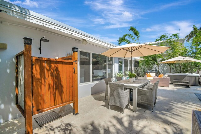 view of patio / terrace with a hot tub and outdoor dining area