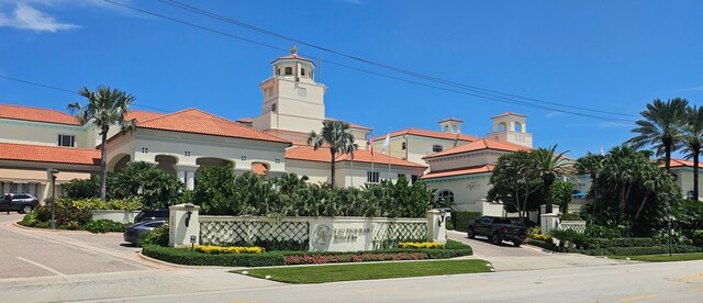 view of property with a water view and uncovered parking