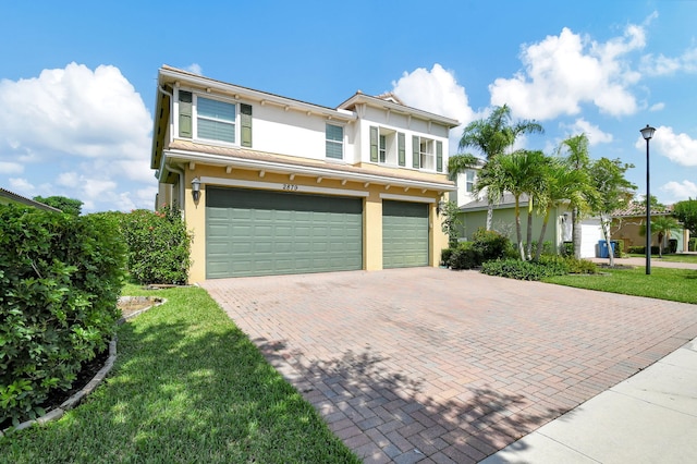 view of front facade featuring a garage and a front yard