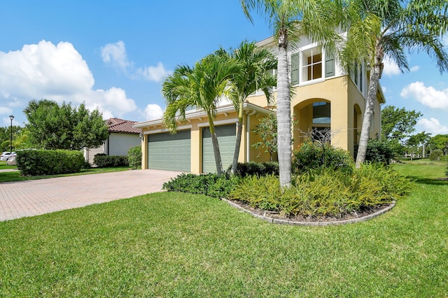 mediterranean / spanish house featuring a front yard