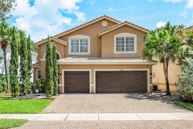 mediterranean / spanish-style home featuring a garage