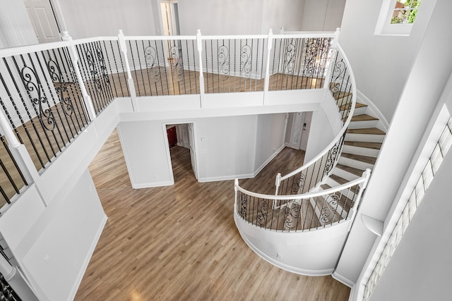 interior space featuring hardwood / wood-style flooring and a towering ceiling