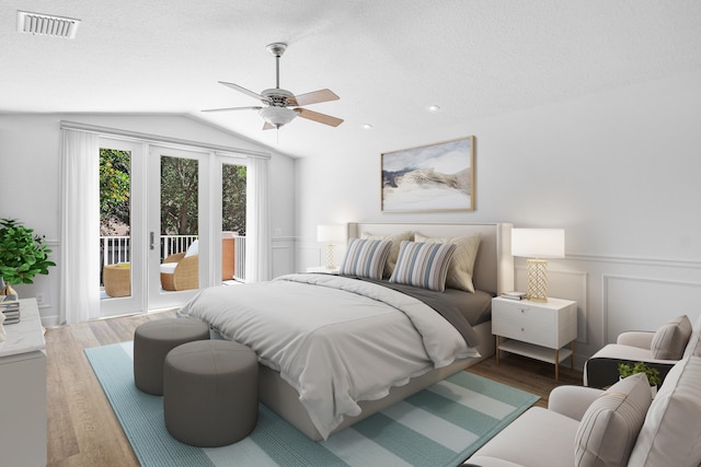 bedroom featuring a textured ceiling, access to outside, ceiling fan, dark hardwood / wood-style floors, and vaulted ceiling