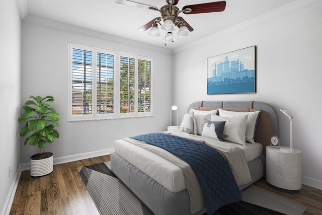 bedroom featuring a textured ceiling, dark wood-type flooring, ceiling fan, and crown molding