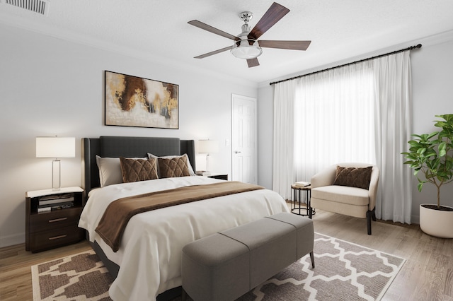 bedroom with ceiling fan, crown molding, and light hardwood / wood-style flooring