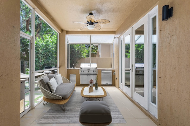 sunroom with ceiling fan and a healthy amount of sunlight