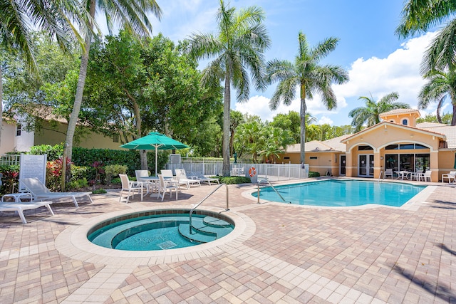 view of swimming pool featuring a community hot tub and a patio