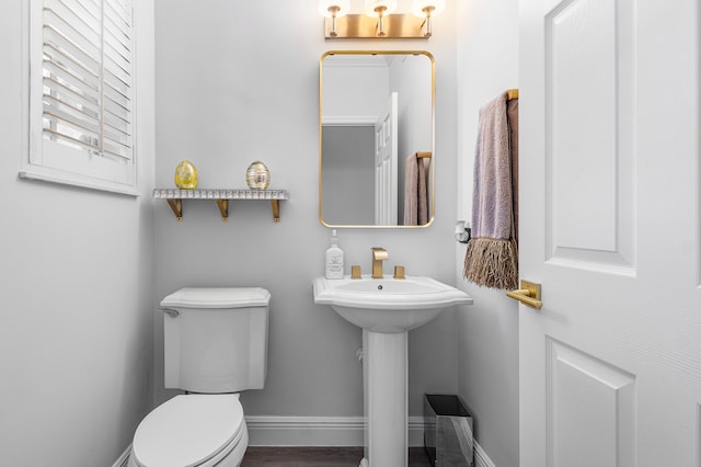 bathroom with toilet and wood-type flooring