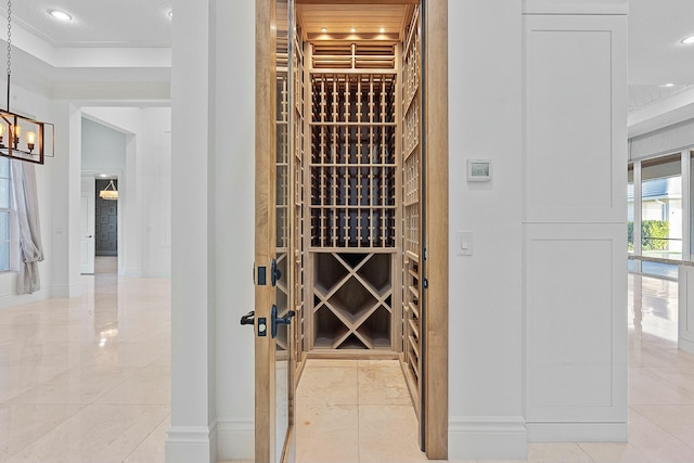 wine cellar with a notable chandelier, recessed lighting, and baseboards