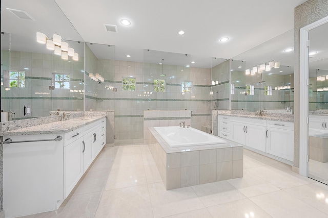 bathroom with tile patterned floors, plus walk in shower, tile walls, and vanity