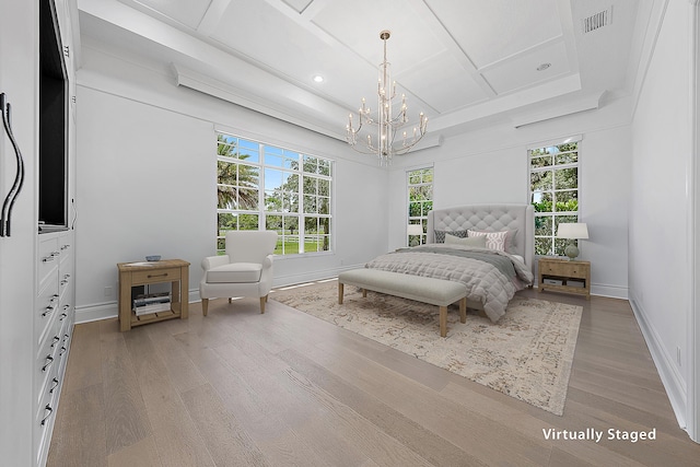 bedroom featuring visible vents, baseboards, light wood-style floors, and coffered ceiling