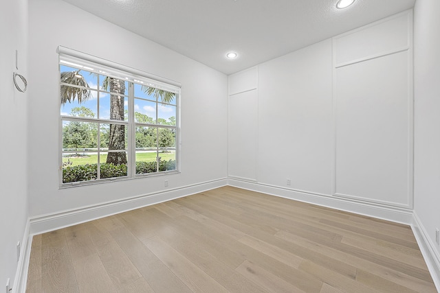 unfurnished room with light wood-type flooring