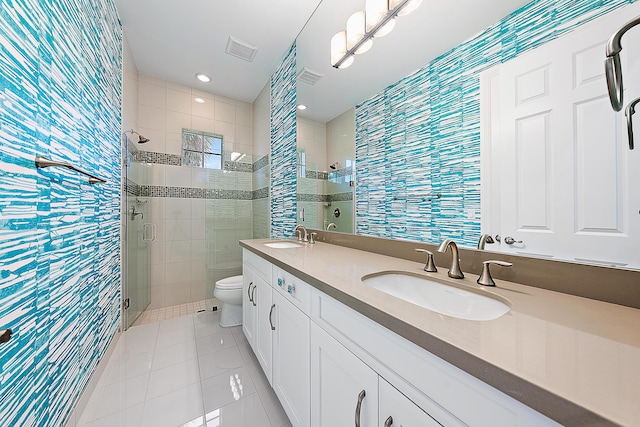 bathroom with walk in shower, vanity, tile patterned floors, and toilet