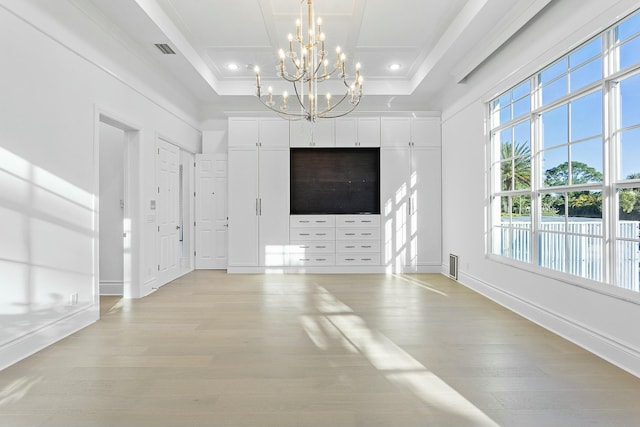 unfurnished living room with visible vents, recessed lighting, baseboards, light wood finished floors, and a raised ceiling