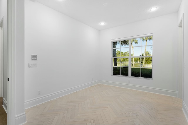 unfurnished room featuring recessed lighting and baseboards