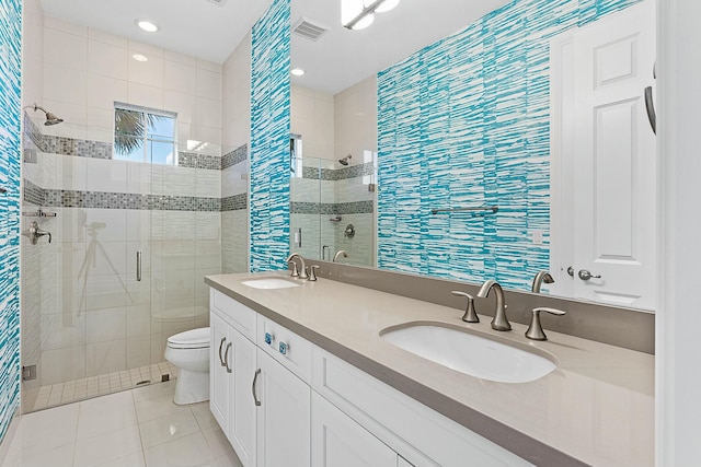 full bathroom featuring tile patterned floors, visible vents, a shower stall, and a sink