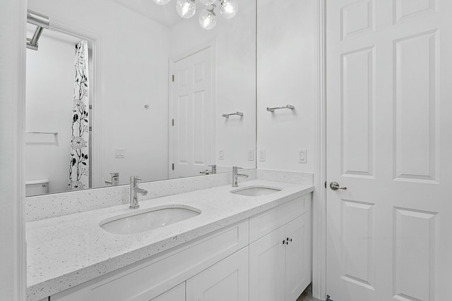 bathroom featuring double vanity and a sink