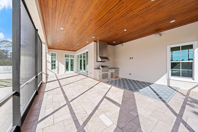 unfurnished sunroom featuring a wealth of natural light and wooden ceiling