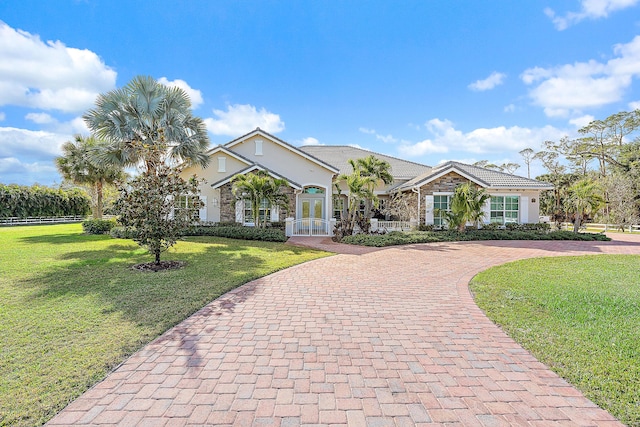 ranch-style house with a front yard and french doors