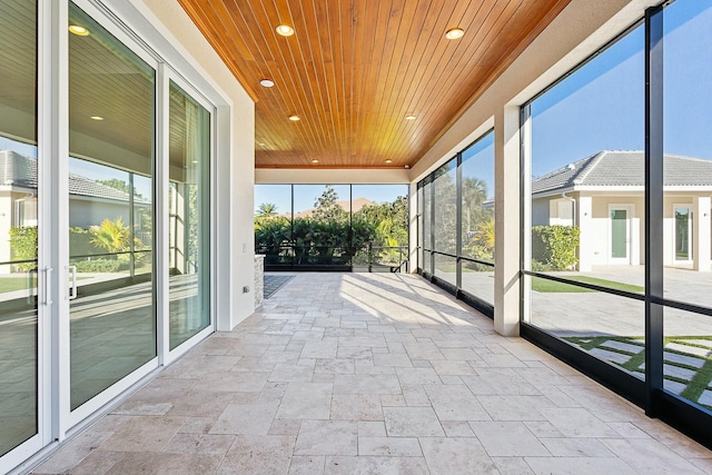 unfurnished sunroom featuring wood ceiling