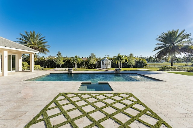 outdoor pool featuring an outdoor structure and a patio area