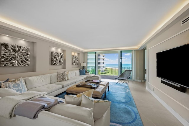 tiled living room featuring floor to ceiling windows